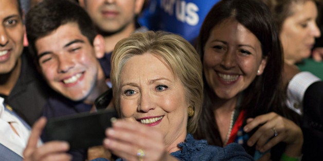 Hillary Clinton, former Secretary of State and 2016 Democratic presidential candidate, center, takes a selfie photograph with