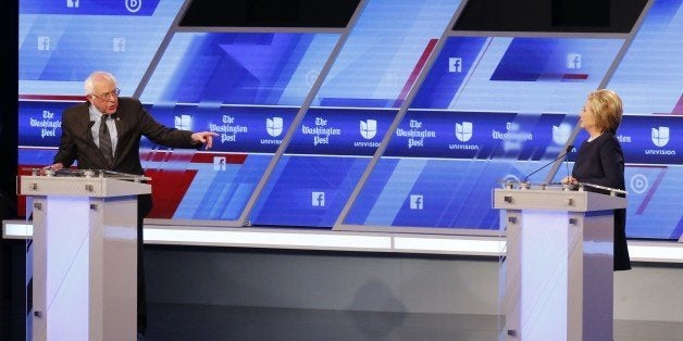 Democratic presidential candidate, Sen. Bernie Sanders, I-Vt, gestures towards Democratic presidential candidate, Hillary Clinton , durings the Univision, Washington Post Democratic presidential debate at Miami-Dade College, Wednesday, March 9, 2016, in Miami, Fla. (AP Photo/Wilfredo Lee)