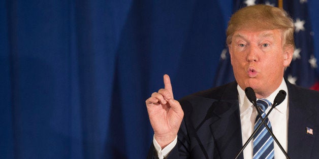 Republican presidential candidate Donald Trump reads from a statement about Pope Francis during a campaign rally in Kiawah, South Carolina, February 17, 2016. Trump cannot claim to be a Christian, Pope Francis said Thursday, after the billionaire vowed to build a border wall to keep out immigrants. 'Anyone, whoever he is, who only wants to build walls and not bridges is not a Christian,' the pontiff told journalists during his return journey from a trip to Mexico in response to a question about Trump's anti-immigrant stance. / AFP / JIM WATSON (Photo credit should read JIM WATSON/AFP/Getty Images)