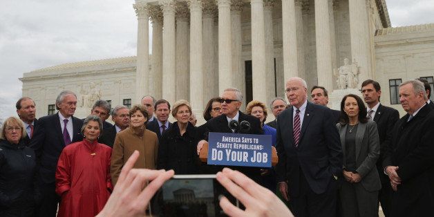 WASHINGTON, DC - FEBRUARY 25: Senate Democrats, including Minority Leader Harry Reid (D-NV) (C), gathered in front of the Supreme Court to hold a news conference and demand that Senate Republicans hold confirmation hearings when President Barack Obama names a news Supreme Court justice nominee February 25, 2016 in Washington, DC. GOP leaders in the Senate said they would not hold a confirmation hearing after Obama said he would name someone to replace Associate Justice Antonin Scalia, who died earlier this month while on a hunting trip in Texas. (Photo by Chip Somodevilla/Getty Images)