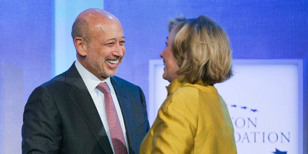 Lloyd Blankfein, left, Chairman and CEO of Goldman Sachs, is greeted by Hillary Rodham Clinton, former Secretary of State, for a panel discussion, "Equality for Girls and Women: 2034 Instead of 2134?" at the Clinton Global Initiative, Wednesday, Sept. 24, 2014 in New York. (AP Photo/Mark Lennihan)