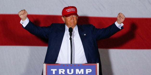 Republican presidential candidate Donald Trump raises his arms during a campaign rally in Boca Raton, Fla., Sunday, March 13,