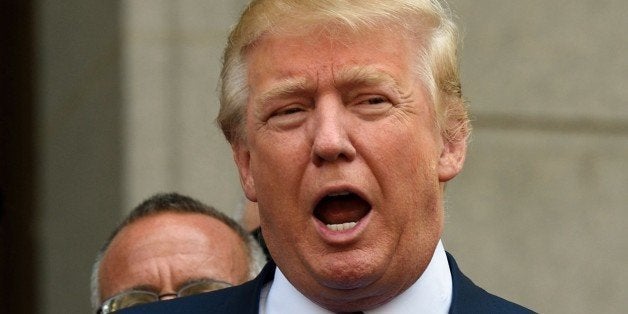 US presidential candidate Donald Trump exits New York Supreme Court after morning jury duty August 17, 2015 in New York. Trump reported for jury duty in New York on Monday, stepping out of a sleek black limo to be mobbed by media and supporters. The bombastic real estate magnate, who is leading the polls among 17 Republican candidates for president, arrived at New York State Supreme Court at 9:08 am (1308 GMT) dressed in a blue suit and striped tie. He strode up the sweeping steps of the court house surrounded by a phalanx of police, television cameras, journalists and photographers, signing an autograph for one fan and fist-bumping another. AFP PHOTO/DON EMMERT / AFP / DON EMMERT (Photo credit should read DON EMMERT/AFP/Getty Images)