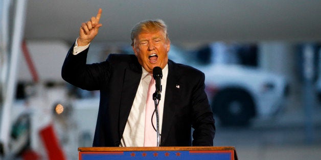 Republican presidential candidate, Donald Trump holds a plane-side rally in a hanger at Youngstown-Warren Regional Airport in Vienna, Ohio, Monday, March 14, 2016. (AP Photo/Gene J. Puskar)