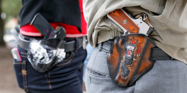 AUSTIN, TX - JANUARY 1: Art and Diana Ramirez of Austin with their pistols in custom-made holsters during and open carry rally at the Texas State Capitol on January 1, 2016 in Austin, Texas. On January 1, 2016, the open carry law takes effect in Texas, and 2nd Amendment activists hold an open carry rally. (Photo by Erich Schlegel/Getty Images)