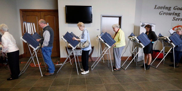 Voters fill the electronic voting machines to cast their ballots during the primary election at the precinct in the Highland Colony Baptist Church in Madison, Miss., on Tuesday, March 8, 2016. Mississippi holds its presidential and congressional primaries today. (AP Photo/Rogelio V. Solis)