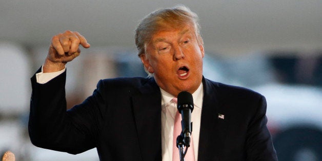 Republican presidential candidate, Donald Trump holds a plane-side rally in a hanger at Youngstown-Warren Regional Airport in Vienna, Ohio, Monday, March 14, 2016. (AP Photo/Gene J. Puskar)