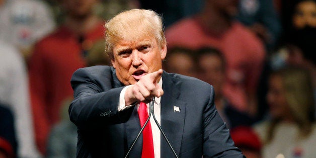 FILE - In this Feb. 26, 2016, file photo, Republican presidential candidate Donald Trump gestures during a speech at a rally in Oklahoma City. Democrats increasingly view Trump as the likely Republican nominee and are seeking consensus on the best way to challenge the billionaire's unpredictable appeal in a general election. (AP Photo/Sue Ogrocki, File)