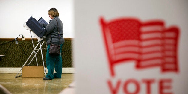 A voter casts her ballot in the primary election Tuesday, March 15, 2016, at an American Legion Hall in Marengo, Ohio. (AP Photo/Matt Rourke)