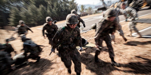 POCHEON, SOUTH KOREA - March 15: A litter team of South Korean Army rushes to a triage station carrying 'wounded' soldier from a Black Hawk during the wounded soldiers evacuation training on Mar. 15, 2016 in The Armed Forces Ildong Hospital, Pocheon, South Korea. (Photo by Shin Woong-jae/For the Washington Post)