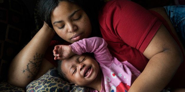 FLINT, MI - MARCH 1: Nakeyja Cade with her one-year-old daughter Zariyah Cade whose blood has tested high for lead in Flint, MI on March 1, 2016. The working single mother of three says Zariyah started having seizures months after she was born and believes that the lead in the water is responsible. Her 3-yr-old son was tested and his levels are not as high. She has yet to test her 50year-old daughter and herself. After trying three different water filters, water in the house is testing high for lead. At night, she bathes the three children in heated, bottled water to avoid further contamination. The City of Flint, through a series of maneuvers, went from using drinking water from Detroit to water from the Flint river. The Flint river water has now been shown to contain trihalomethanes, a chlorine byproduct linked to cancer and other diseases. A study by the Hurley Medical Center stated the proportion of infants and children had an extremely above-average levels of lead in their blood which had nearly doubled since the city switched its water source. (Photo by Linda Davidson / The Washington Post via Getty Images)