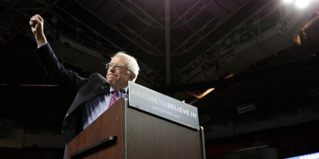 Democratic presidential candidate Bernie Sanders greets the crowd during a rally at Key Arena on March 20, 2016 in Seattle. /