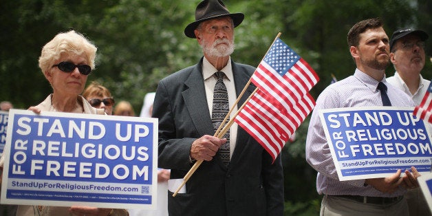 CHICAGO, IL - JUNE 30: Religious freedom supporters hold a rally to praise the Supreme Court's decision in the Hobby Lobby, contraception coverage requirement case on June 30, 2014 in Chicago, Illinois. Oklahoma-based Hobby Lobby, which operates a chain of arts-and-craft stores, challenged the provision and the high court ruled 5-4 that requiring family-owned corporations to pay for insurance coverage for contraception under the Affordable Care Act violated a federal law protecting religious freedom. (Photo by Scott Olson/Getty Images)