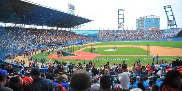 People wait for the start of a baseball exhibition game between Cuba and US Tampa Bay Rays at the Latinoamericano Stadium in