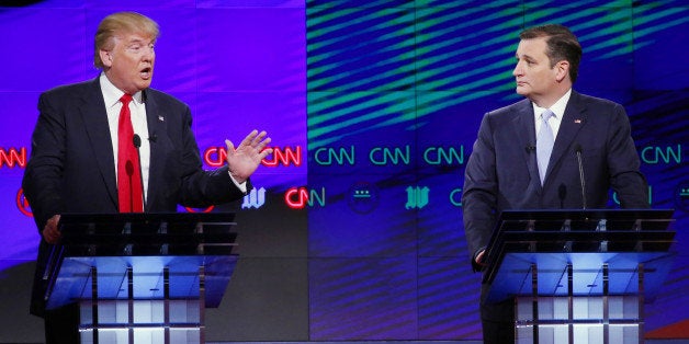 Republican presidential candidate, businessman Donald Trump, speaks as Republican presidential candidate, Sen. Ted Cruz, R-Texas, listens during a Republican presidential debate sponsored by CNN, Salem Media Group and the Washington Times at the University of Miami, Thursday, March 10, 2016, in Coral Gables, Fla. (AP Photo/Wilfredo Lee)