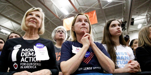 Supporters listen as Democratic presidential candidate Hillary Clinton speaks during a rally at Rainer Beach High School in S