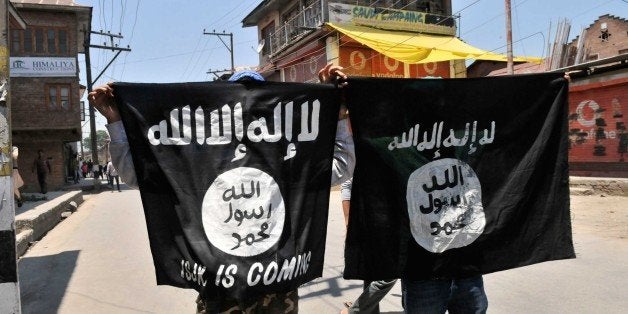 SRINAGAR, INDIA - JUNE 27: Kashmiri protesters displaying the flags of ISIS during a protest against alleged desecration of Jamia Masjid by police personnel yesterday after Friday prayers, on June 27, 2015 in Srinagar, India. Clashes broke out in several parts of downtown Srinagar on Saturday against the alleged desecration of Jamia Masjid by government forces yesterday. Reacting very sharply against police action, Auqaf Jamia Masjid, which functions under Mirwaiz, called for a shutdown in Srinagar followed by Geelani, Malik and Shah. (Photo by Waseem Andrabi/Hindustan Times via Getty Images)