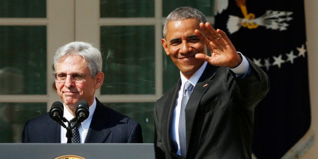 U.S. President Barack Obama waves after Judge Merrick Garland's (L) remarks after announcing Garland as his nominee for the U