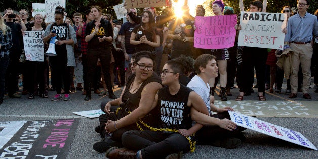 Front from left, demonstrators Jess Jude, Loan Tran and Noah Rubin-Blose, sit chained together in the middle of the street during a protest against House Bill 2 on Thursday, March 24, 2016, outside of the Governor's Mansion on North Blount Street in downtown Raleigh, N.C. (Jill Knight/Raleigh News & Observer/TNS via Getty Images)