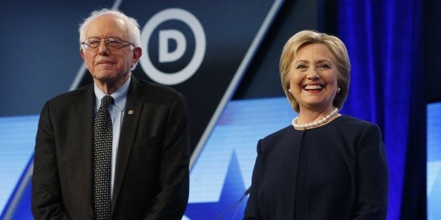 Democratic presidential candidates, Hillary Clinton and Sen. Bernie Sanders, I-Vt, stand together before the start of the Un