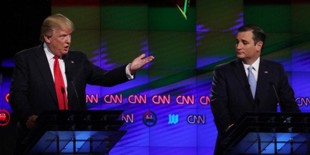 Republican U.S. presidential candidate Donald Trump speaks as rival Ted Cruz (R) listens during the Republican candidates debate sponsored by CNN at the University of Miami in Miami, Florida, March 10, 2016. REUTERS/Carlo Allegri