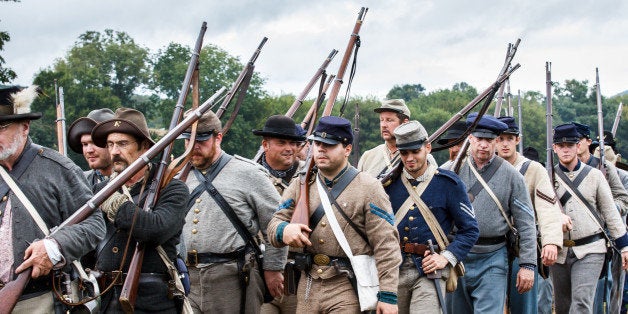Confederate Soldiers in Military Uniform and With Rifles March to the Battlefield During the 150th Anniversary of the Histori