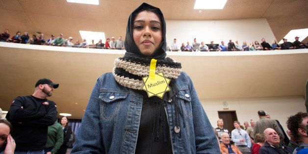 WICHITA, KS - MARCH 5: Rabya Ahmed listens as Republican presidential candidate Donald Trump makes a speech at a campaign rally on March 5, 2016 in Wichita, Kansas where the Republican party was staging one of its statewide caucus. She and other Muslim protesters were asked to leave the rally (Photo by J Pat Carter/Getty Images)