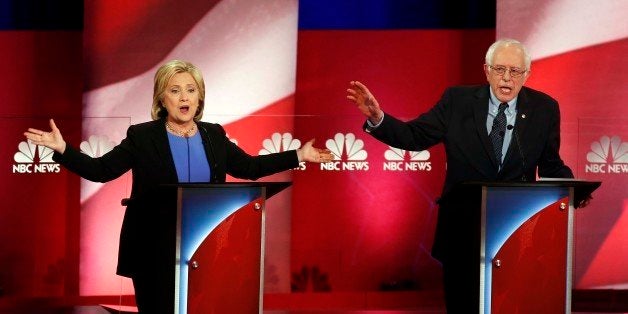 Democratic presidential candidates, former Secretary of State Hillary Clinton, left, and Sen. Bernie Sanders, I-Vt. talk over each other during the democratic presidential primary debate at the Gaillard Center, Sunday, Jan. 17, 2016, in Charleston, S.C. (AP Photo/Mic Smith)