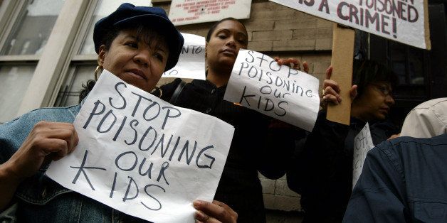 NEW YORK - OCTOBER 22: Mothers who live in apartments with high lead levels protest outside of a lead contaminated building October 22, 2003 in New York City. A new study released October 22, 2003 by the Northern Manhattan Improvement Corporation has concluded that 1 in 4 children in some parts of New York are at risk for lead poisoning. Children ingest lead paint and lead paint dust, resulting in lead poisoning, which causes irreversible brain and central nervous system damage. While lead paint was banned in housing construction in New York in 1960, buildings built before 1960 still have high amounts of lead which landlords, especially in impoverished neighborhoods, are reluctant to remove. (Photo by Spencer Platt/Getty Images)