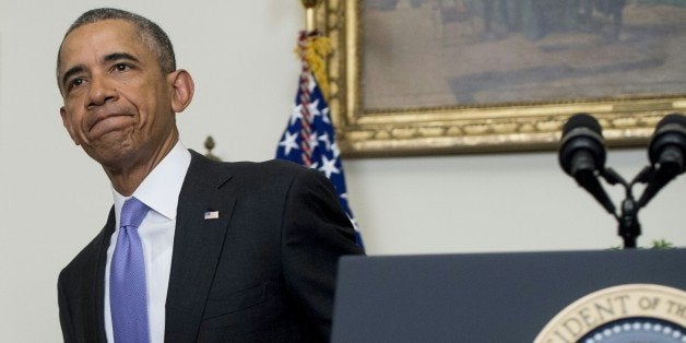 US President Barack Obama leaves after speaking about US - Iranian relations, including the Iranian-American nationals that were jailed in Iran and are being freed as part of a prisoner swap, in the Cabinet Room of the White House in Washington, DC, January 17, 2016. The presidential statement comes after the lifting of international sanctions against Iran as part of a nuclear deal capped by a US-Iranian prisoner exchange. / AFP / SAUL LOEB (Photo credit should read SAUL LOEB/AFP/Getty Images)