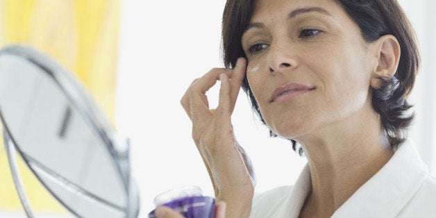 Woman applying eye cream