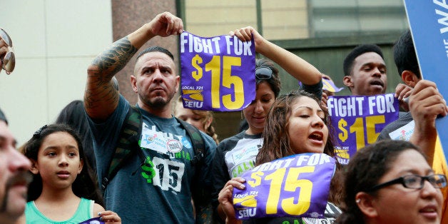 FILE - In this Tuesday, July 21, 2015 file photo, workers hold a rally in Los Angeles in support of the Los Angeles County Board of Supervisors' proposed minimum wage ordinance. On Saturday, March 26, California legislators and labor unions reached an agreement that will take the state's minimum wage from $10 to $15 an hour. (AP Photo/Nick Ut)