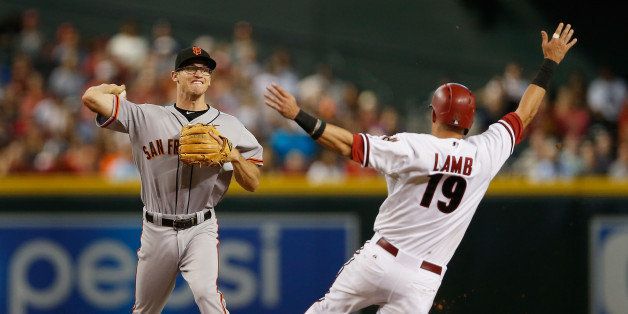 PHOENIX, AZ - SEPTEMBER 07: Infielder Kelby Tomlinson #37 of the San Fransisco Giants throws over the sliding Jake Lamb #19 of the Arizona Diamondbacks to complete a double play during the fifth inning of the MLB game at Chase Field on September 7, 2015 in Phoenix, Arizona. (Photo by Christian Petersen/Getty Images)