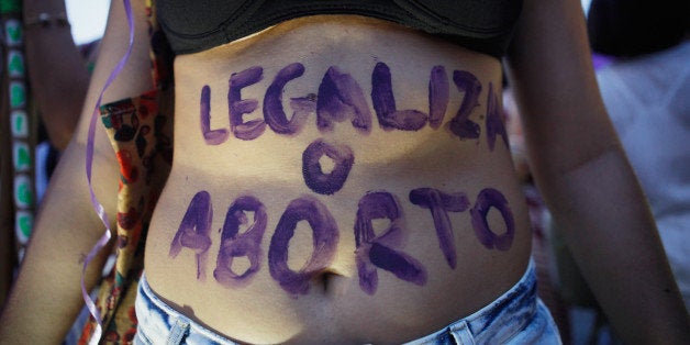 RIO DE JANEIRO, BRAZIL - MARCH 08: A supporter of legalizing abortion poses during a march for women's rights on Internation