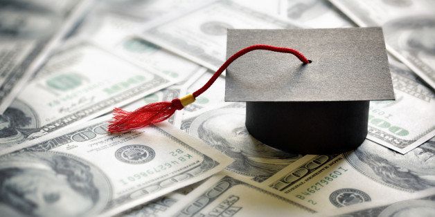 Graduation mortar board cap on one hundred dollar bills concept for the cost of a college and university education