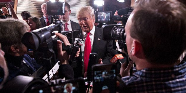 Donald Trump, president and chief executive of Trump Organization Inc. and 2016 Republican presidential candidate, center, speaks to the media in the spin-room following the Republican presidential candidate debate sponsored by CBS News and the Republican National Committee at the Peace Center in Greenville, South Carolina, U.S., on Saturday, Feb. 13, 2016. Donald Trump tops the GOP field with support from 36.3 percent of likely South Carolina Republican primary voters with Ted Cruz at 19.6 percent, according to a poll conducted for the Augusta Chronicle released on Friday. Photographer: Daniel Acker/Bloomberg via Getty Images 