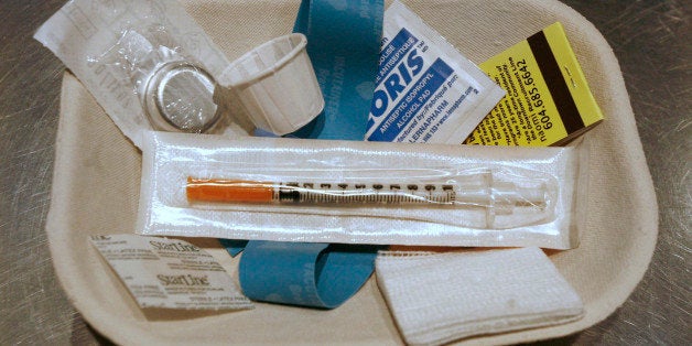 A small kit of supplies containing syringes, bandaids and antiseptic pads waits to be used by a drug addict inside a safe inj