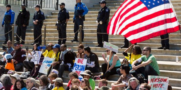 UNITED STATES - APRIL 13 - U.S. Capitol Police officers watch over Democracy Spring protesters calling for the end of big money in politics gather on the Capitol steps on the East Plaza of the Capitol on Wednesday April 13, 2016. (Photo By Al Drago/CQ Roll Call)