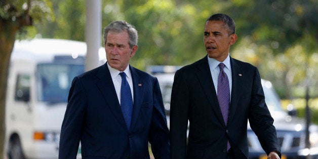 U.S. President Barack Obama (R) and former President George W. Bush attend a memorial for the victims of the 1998 U.S. Embass