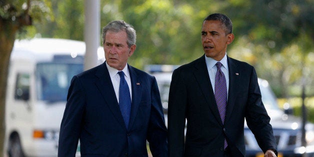 U.S. President Barack Obama (R) and former President George W. Bush attend a memorial for the victims of the 1998 U.S. Embassy bombing in Dar es Salaam July 2, 2013. REUTERS/Jason Reed (TANZANIA - Tags: POLITICS)