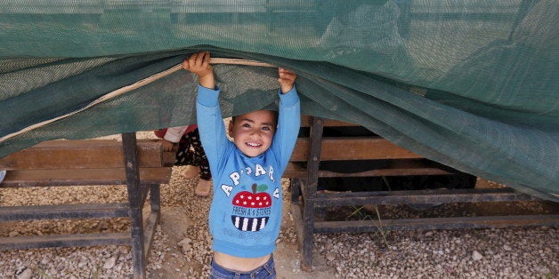 A Syrian child plays during a visit by actress Ashley Judd, U.N. Population Fund (UNFPA) Goodwill Ambassador, to Al Zaatari refugee camp in the Jordanian city of Mafraq, near the border with Syria, April 10, 2016. REUTERS/Muhammad Hamed