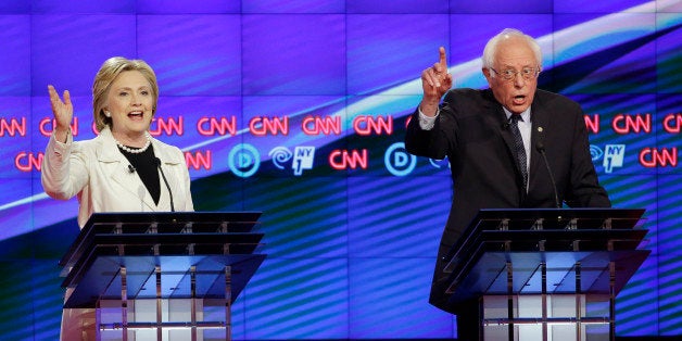 Democratic presidential candidates Sen. Bernie Sanders, I-Vt., right, and Hillary Clinton speak during the CNN Democratic Presidential Primary Debate at the Brooklyn Navy Yard on Thursday, April 14, 2016 in New York. (AP Photo/Seth Wenig)