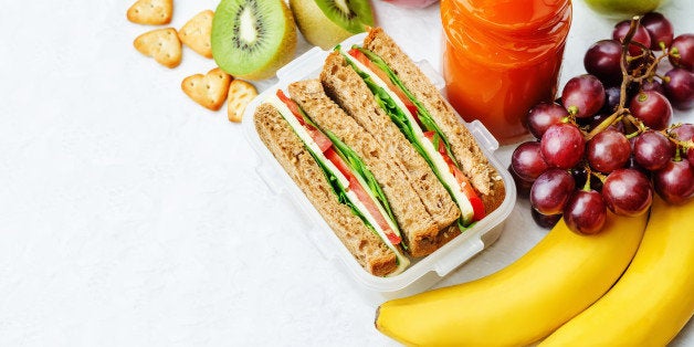 school lunch with a sandwich, fresh fruits, crackers and juice. the toning. selective focus