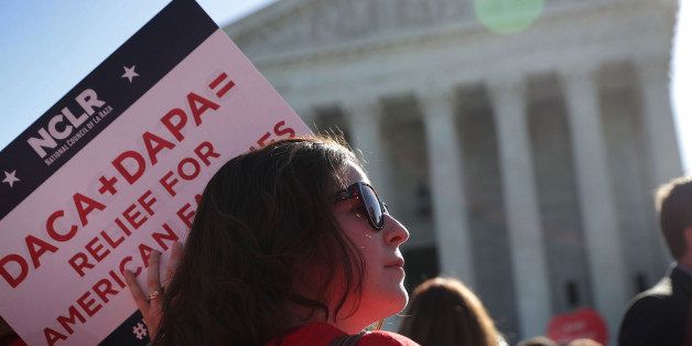 WASHINGTON, DC - APRIL 18: A pro-immigration activist holds a sign in front of the U.S. Supreme Court on April 18, 2016 in Washington, DC. The Supreme Court is scheduled to hear oral arguments in the case of United States v. Texas, which is challenging President Obama's 2014 executive actions on immigration - the Deferred Action for Childhood Arrivals (DACA) and Deferred Action for Parents of Americans and Lawful Permanent Residents (DAPA) programs. (Photo by Alex Wong/Getty Images)