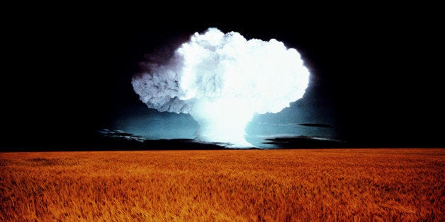 Wheat field, mushroom cloud on horizon (digital composite)