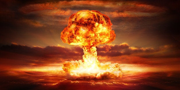 testing of atomic bomb over ocean with mushroom clouds - red destroy