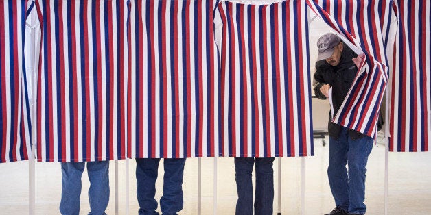 CONCORD, NH - FEBRUARY 9: People mark their ballots for the New Hampshire primary in booths at Immaculate Conception Church i