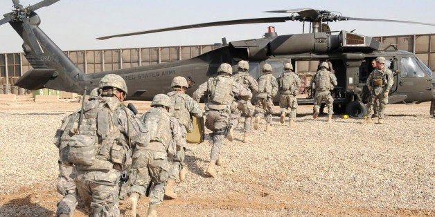 U.S. soldiers assigned to Troop B, 5th Squadron, 73rd Cavalry Regiment, 3rd Brigade Combat Team, 82nd Airborne Division, Multi-National Division-Baghdad run toward a UH-60 Blackhawk helicopter during an air assault training event in Baghdad February 25, 2009. President Barack Obama's plan to pull U.S. combat troops out in 18 months won't plunge Iraq back into chaos, but the United States will need to use adroit diplomacy to quell fresh conflicts between rival Iraqi groups. Picture taken February 25, 2009. REUTERS/U.S. Army/Staff Sgt. James Selesnick/Handout (IRAQ)