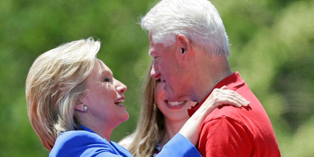 Democratic presidential candidate, former Secretary of State Hillary Rodham Clinton, left, hugs her husband former President Bill Clinton after speaking to supporters Saturday, June 13, 2015, on Roosevelt Island in New York. (AP Photo/Frank Franklin II)