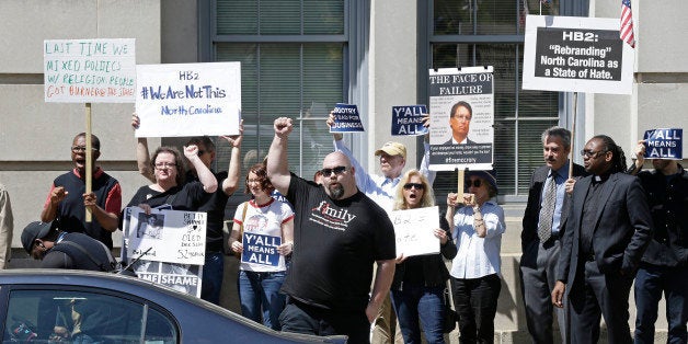 Opponents of House Bill 2 protest across the street from the North Carolina State Capitol in Raleigh, N.C., Monday, April 11, 2016 during a rally in support of the law that blocks rules allowing transgender people to use the bathroom aligned with their gender identity. (AP Photo/Gerry Broome)